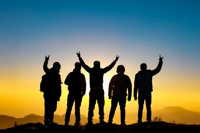 silhouette of people raising their hands